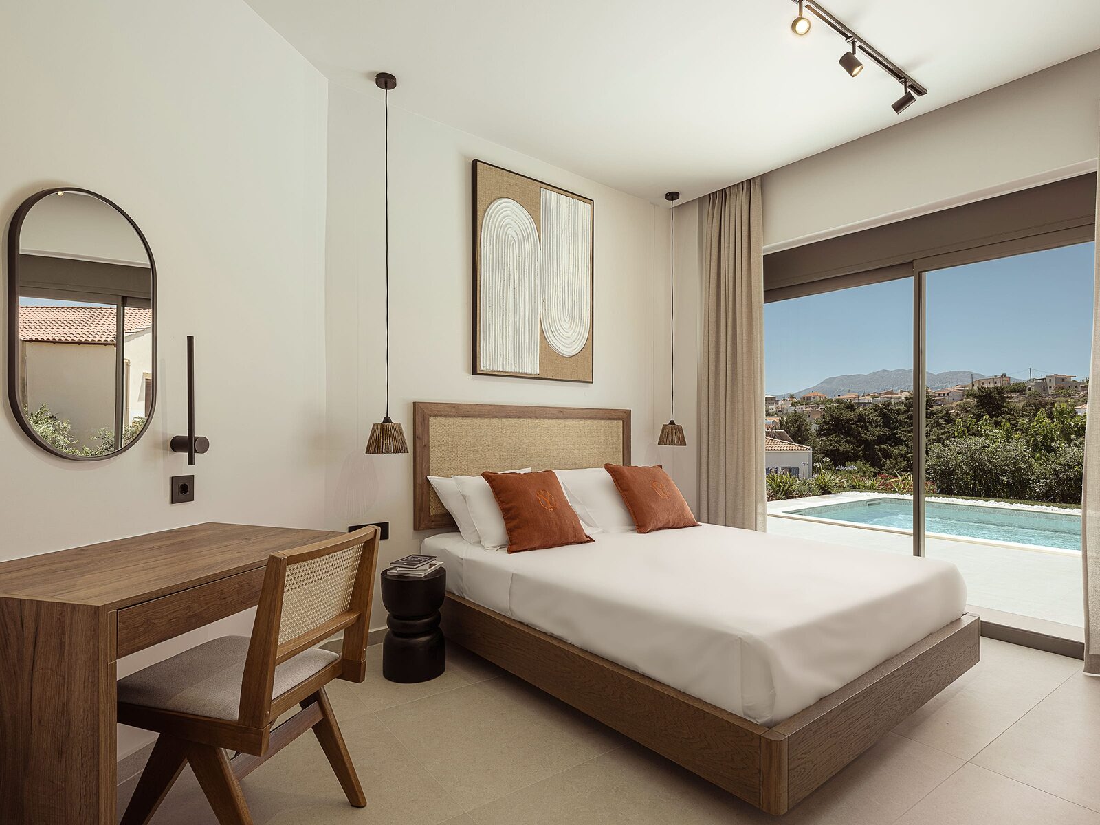 Bedroom with desk and pool view