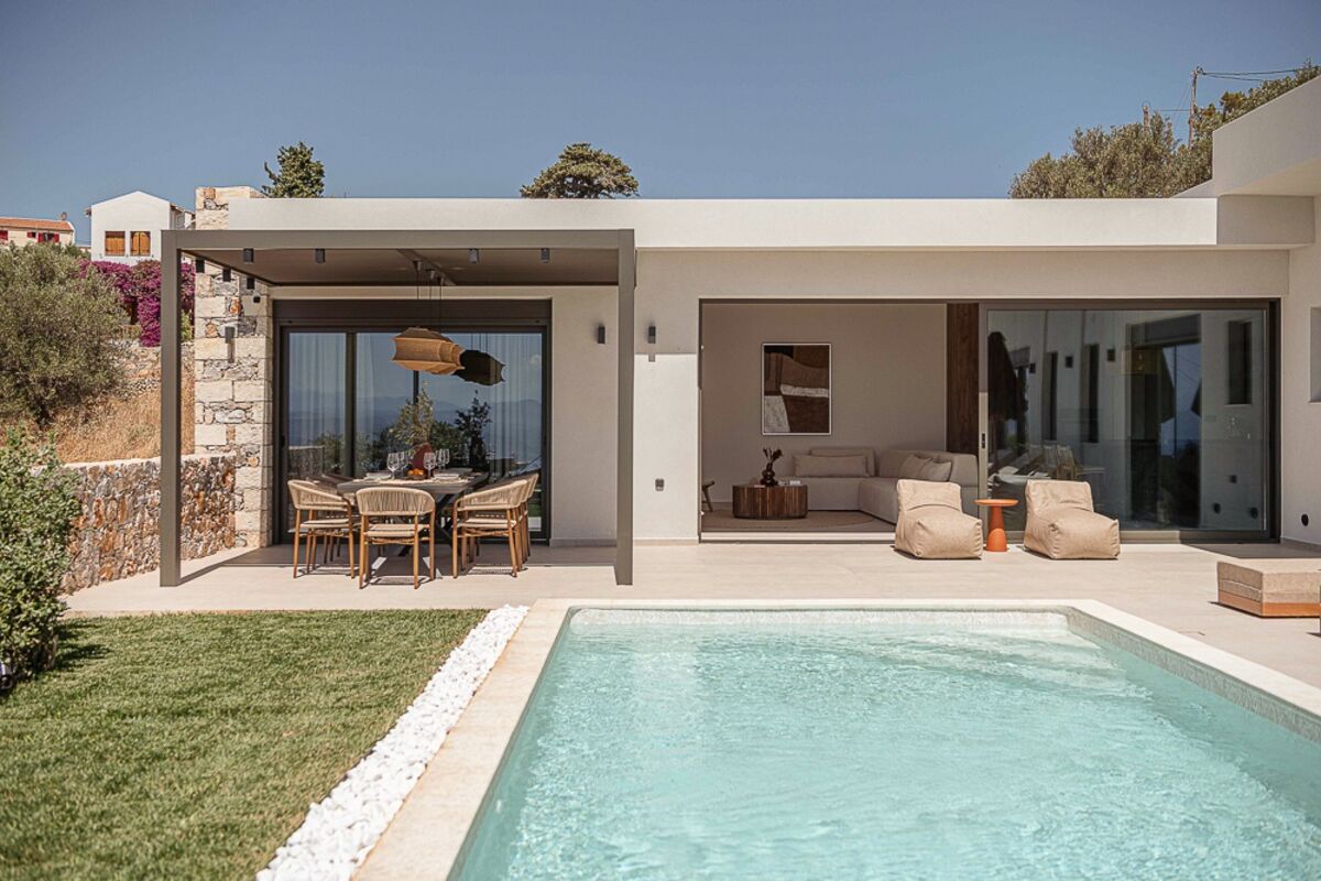 Villa facade with open living space and pool